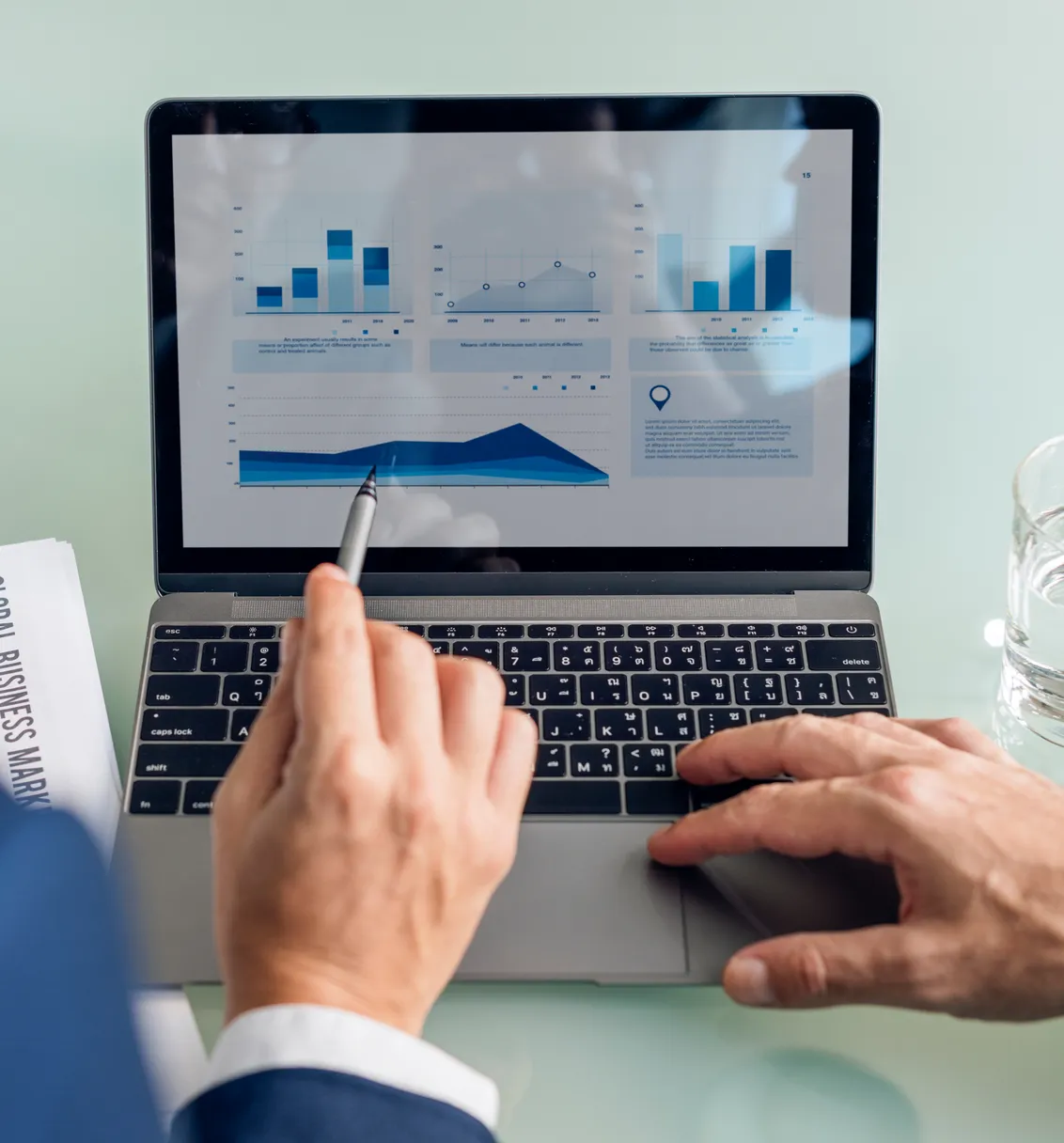 Pointing at charts on a laptop