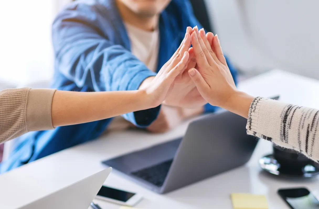 Three hands joining together